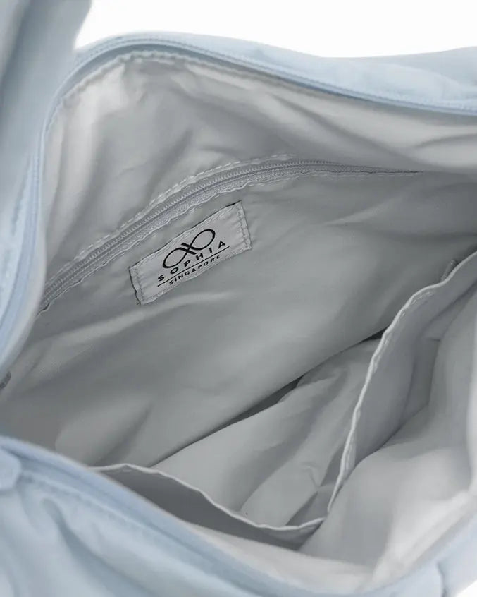 SIGNATURE POCKET CROSSBODY BAG IN COSY LUXE FROST 