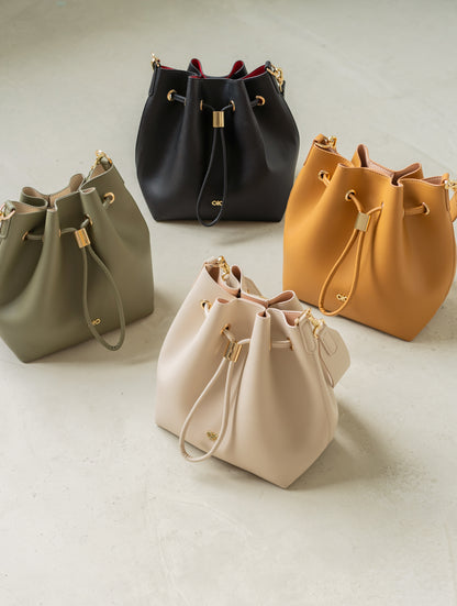 MINI REINA MAGIC BUCKET BAG IN CAMEL